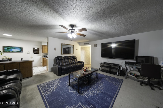 living room with a textured ceiling and ceiling fan