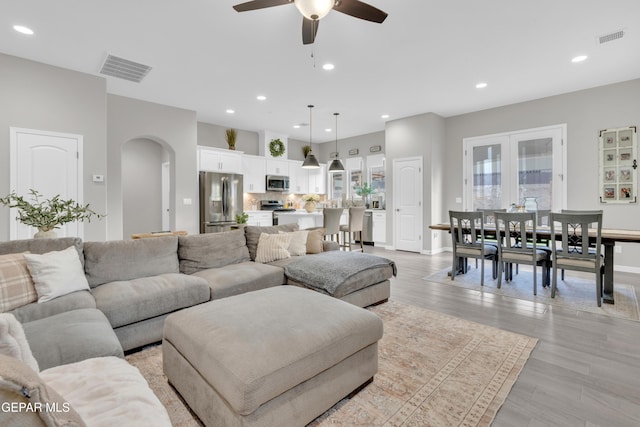 living room featuring ceiling fan and light hardwood / wood-style floors