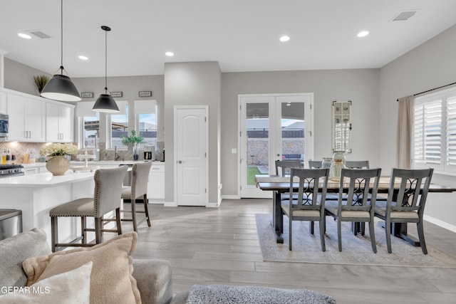 dining area featuring a wealth of natural light and light hardwood / wood-style floors