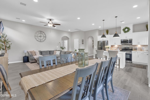 dining space featuring light wood-type flooring and ceiling fan