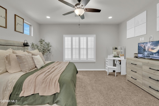 carpeted bedroom with ceiling fan and multiple windows