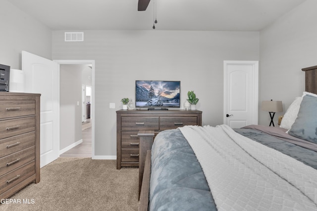 bedroom featuring connected bathroom, light colored carpet, and ceiling fan