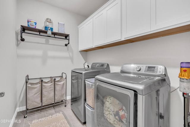 laundry room featuring cabinets and independent washer and dryer