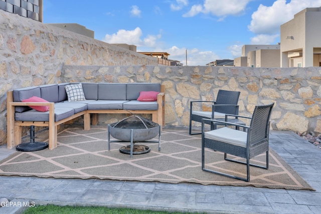 view of patio featuring an outdoor living space with a fire pit