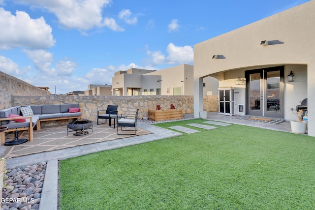 view of yard featuring an outdoor fire pit and a patio area