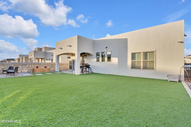 back of property featuring a yard and a patio area