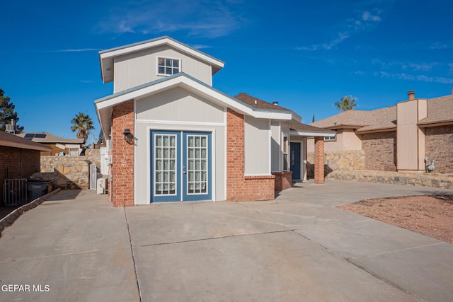 view of front of house featuring a patio area and french doors