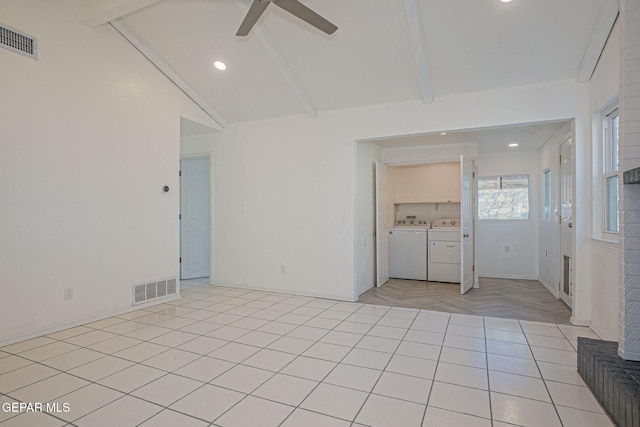 spare room with ceiling fan, light tile patterned floors, lofted ceiling with beams, and washer and dryer