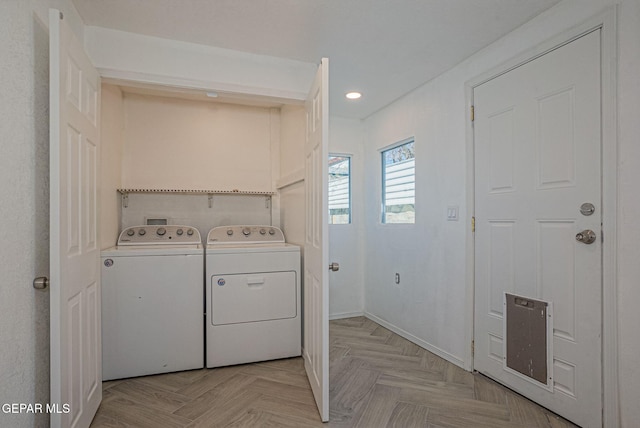 washroom featuring light parquet flooring and independent washer and dryer