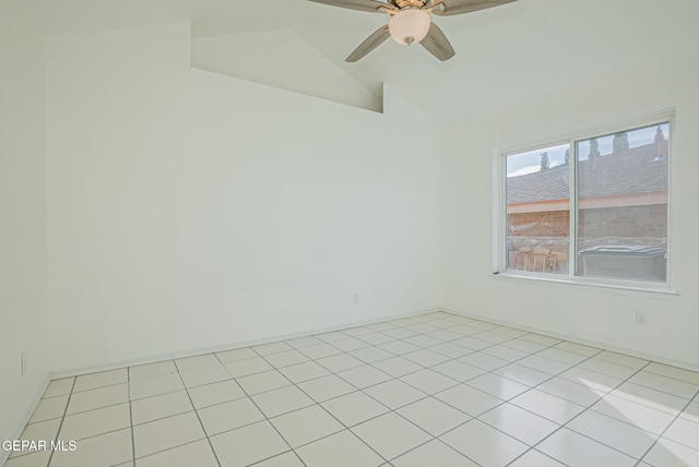 tiled empty room featuring lofted ceiling and ceiling fan