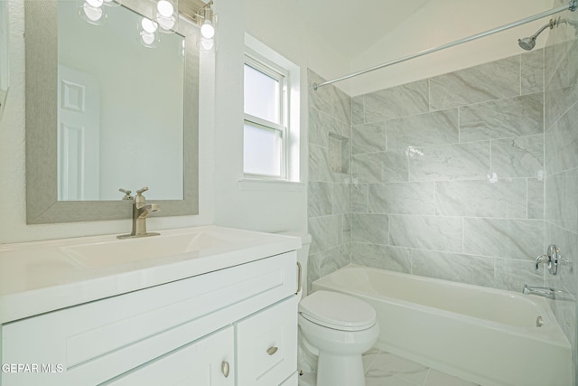 full bathroom featuring toilet, vaulted ceiling, tiled shower / bath, and vanity