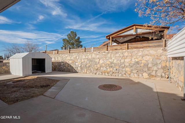 view of patio featuring a shed