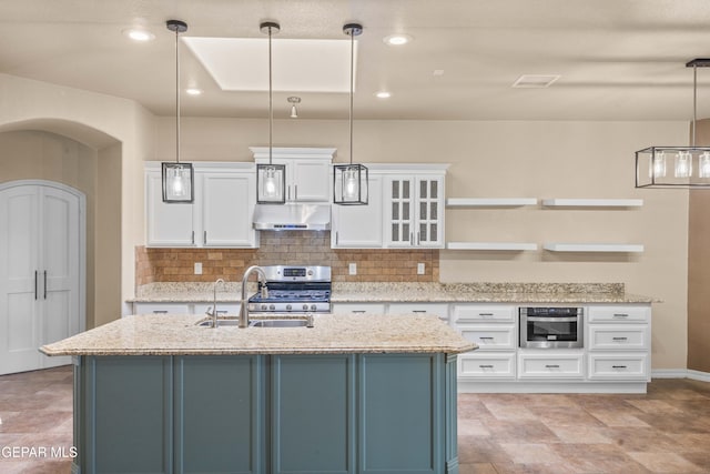 kitchen with stainless steel range, hanging light fixtures, and white cabinets