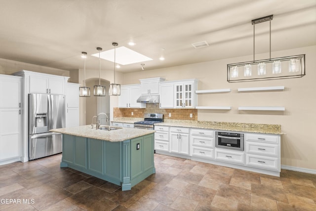 kitchen with white cabinetry, hanging light fixtures, a skylight, green cabinetry, and stainless steel appliances