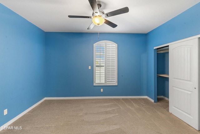 unfurnished bedroom with ceiling fan, a closet, and carpet floors