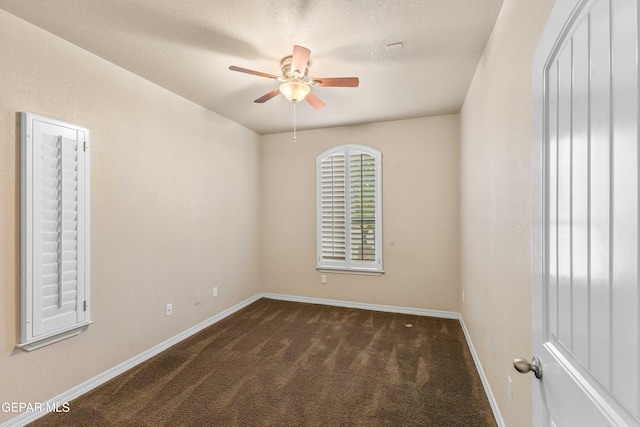 empty room featuring ceiling fan and dark carpet