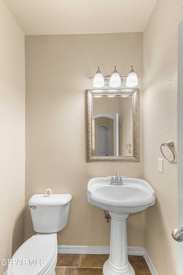 bathroom featuring tile patterned floors and toilet