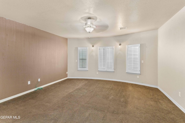 spare room with ceiling fan, a textured ceiling, and carpet floors