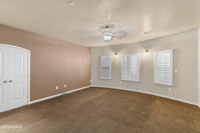 carpeted empty room featuring a textured ceiling and ceiling fan