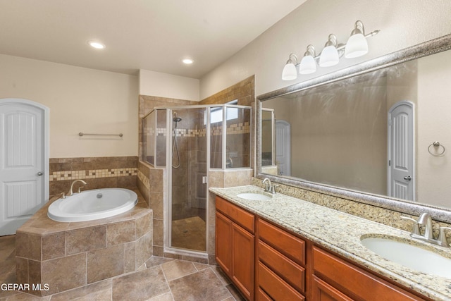 bathroom with shower with separate bathtub and vanity