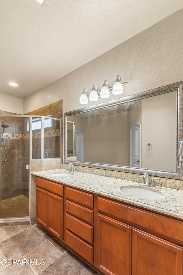 bathroom featuring walk in shower and vanity