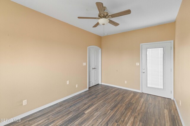 empty room featuring ceiling fan and dark hardwood / wood-style floors