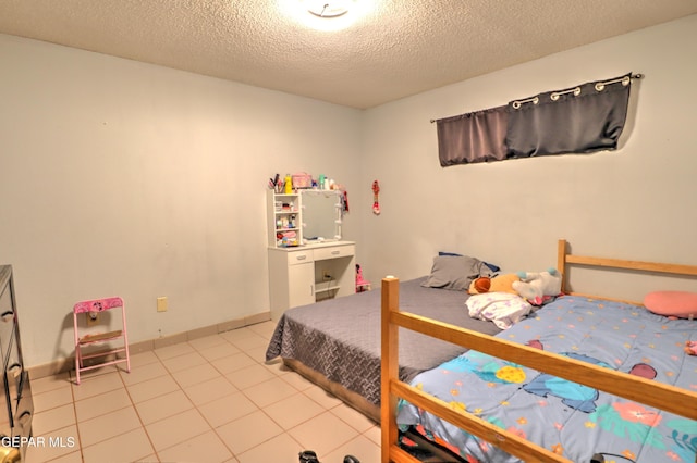 tiled bedroom with a textured ceiling