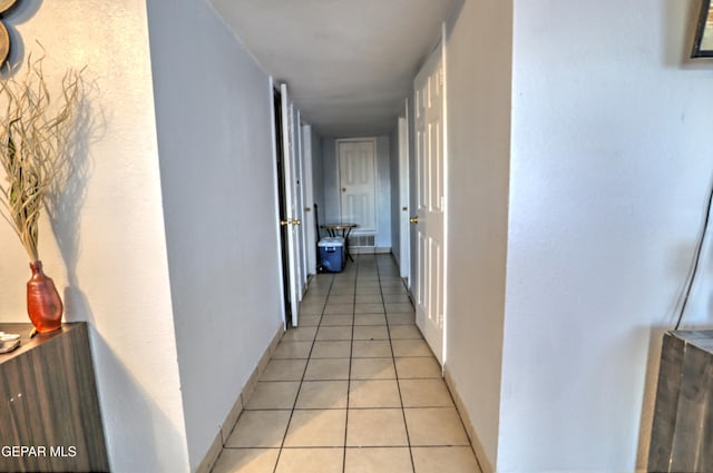 hall featuring light tile patterned floors