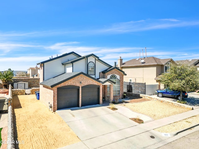 traditional-style home with brick siding, fence, driveway, and an attached garage