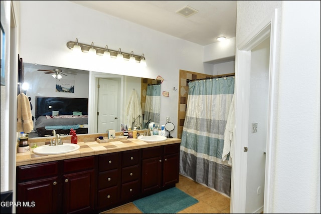 bathroom with vanity, tile patterned floors, ceiling fan, and walk in shower