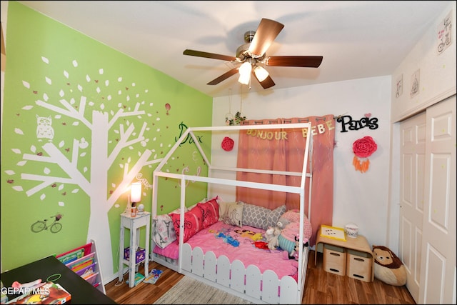 bedroom featuring hardwood / wood-style flooring, ceiling fan, and a closet