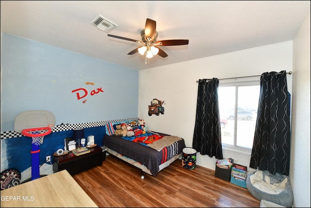 bedroom with hardwood / wood-style flooring and ceiling fan