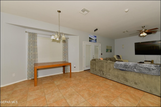 tiled living room featuring ceiling fan with notable chandelier