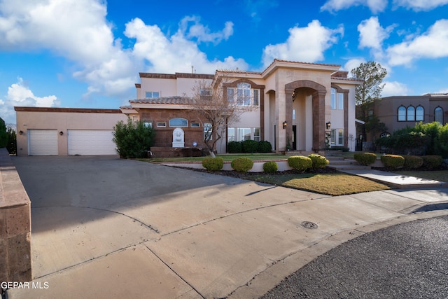 mediterranean / spanish house featuring a garage