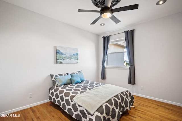 bedroom with ceiling fan and hardwood / wood-style floors