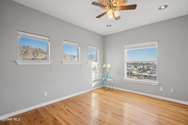 empty room featuring ceiling fan and light hardwood / wood-style flooring