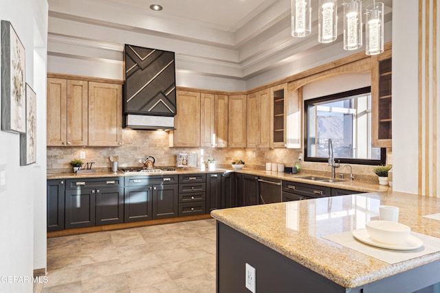 kitchen with decorative backsplash, light stone counters, hanging light fixtures, and sink