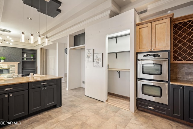 kitchen featuring pendant lighting, crown molding, light stone countertops, light brown cabinets, and double oven