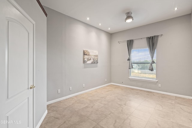 spare room featuring light tile patterned flooring