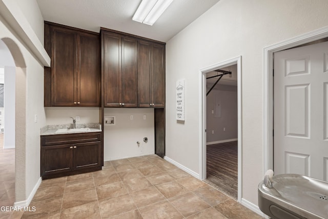 laundry area featuring cabinets, sink, hookup for a washing machine, and hookup for a gas dryer