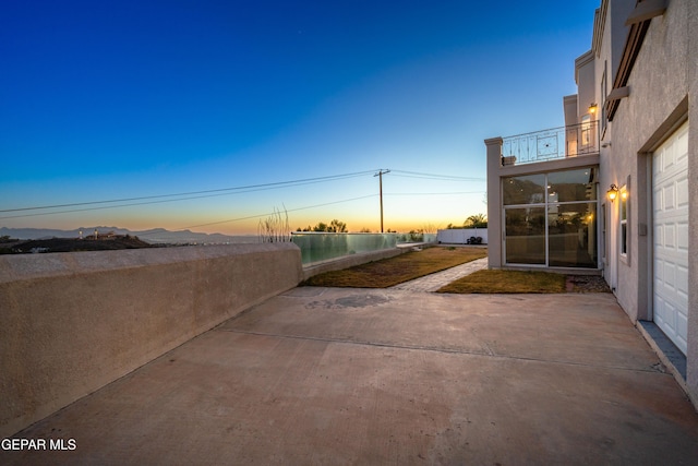 patio terrace at dusk with a balcony