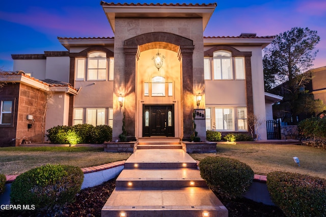 mediterranean / spanish-style house featuring a lawn