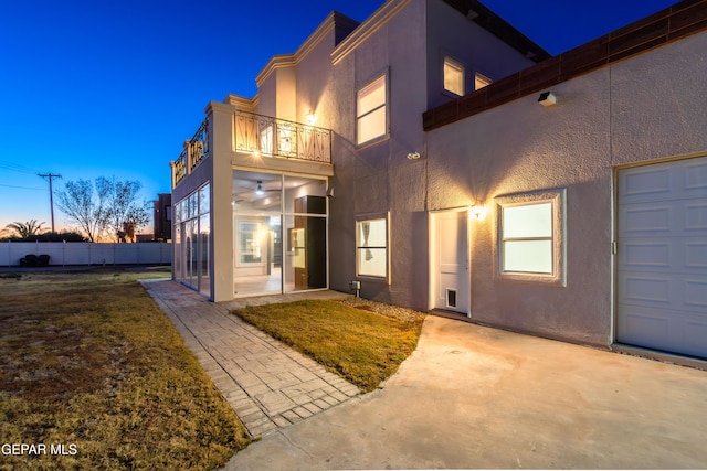 exterior entry at dusk with a balcony