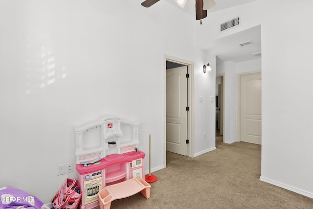 playroom featuring light carpet and ceiling fan