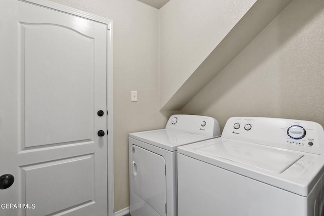 clothes washing area featuring separate washer and dryer