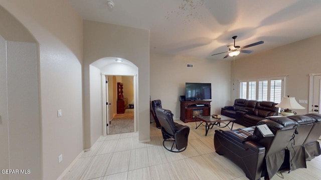 tiled living room featuring ceiling fan