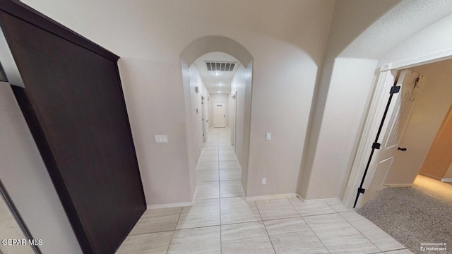 hall with light tile patterned flooring