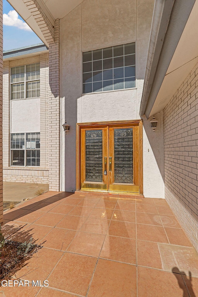 property entrance featuring french doors and a patio