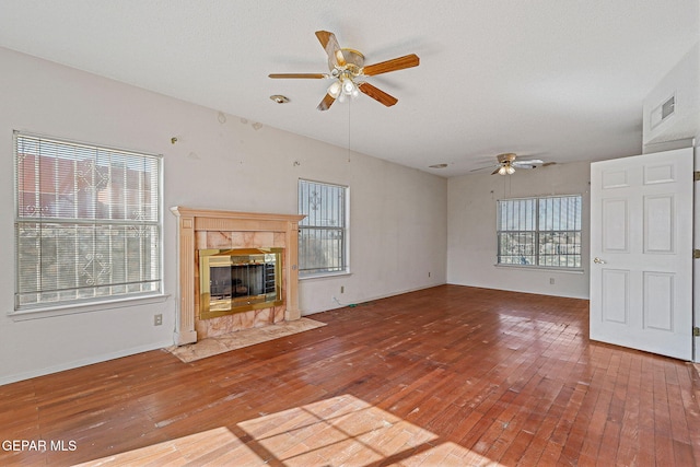 unfurnished living room featuring a fireplace and wood-type flooring