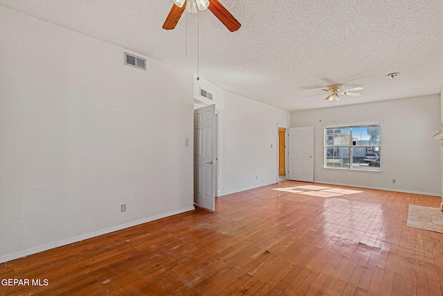 unfurnished living room with ceiling fan, a textured ceiling, and hardwood / wood-style flooring